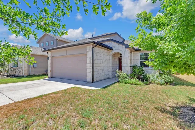 a house that has a tree in front of it