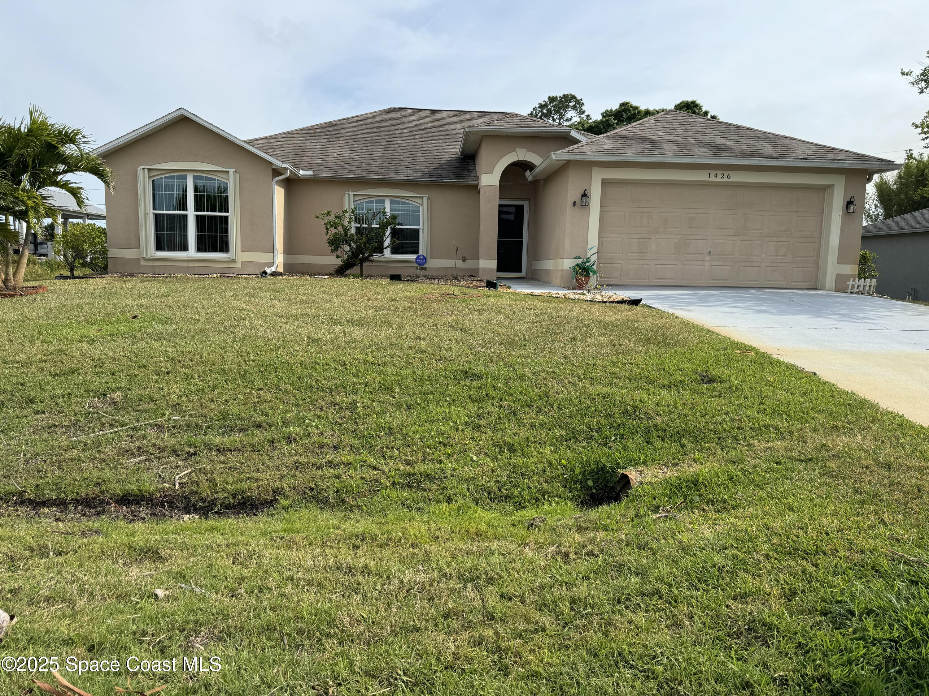 Undisclosed Address Palm Bay, FL 32909 - Photo 1 of 20 a front view of a house with a yard
