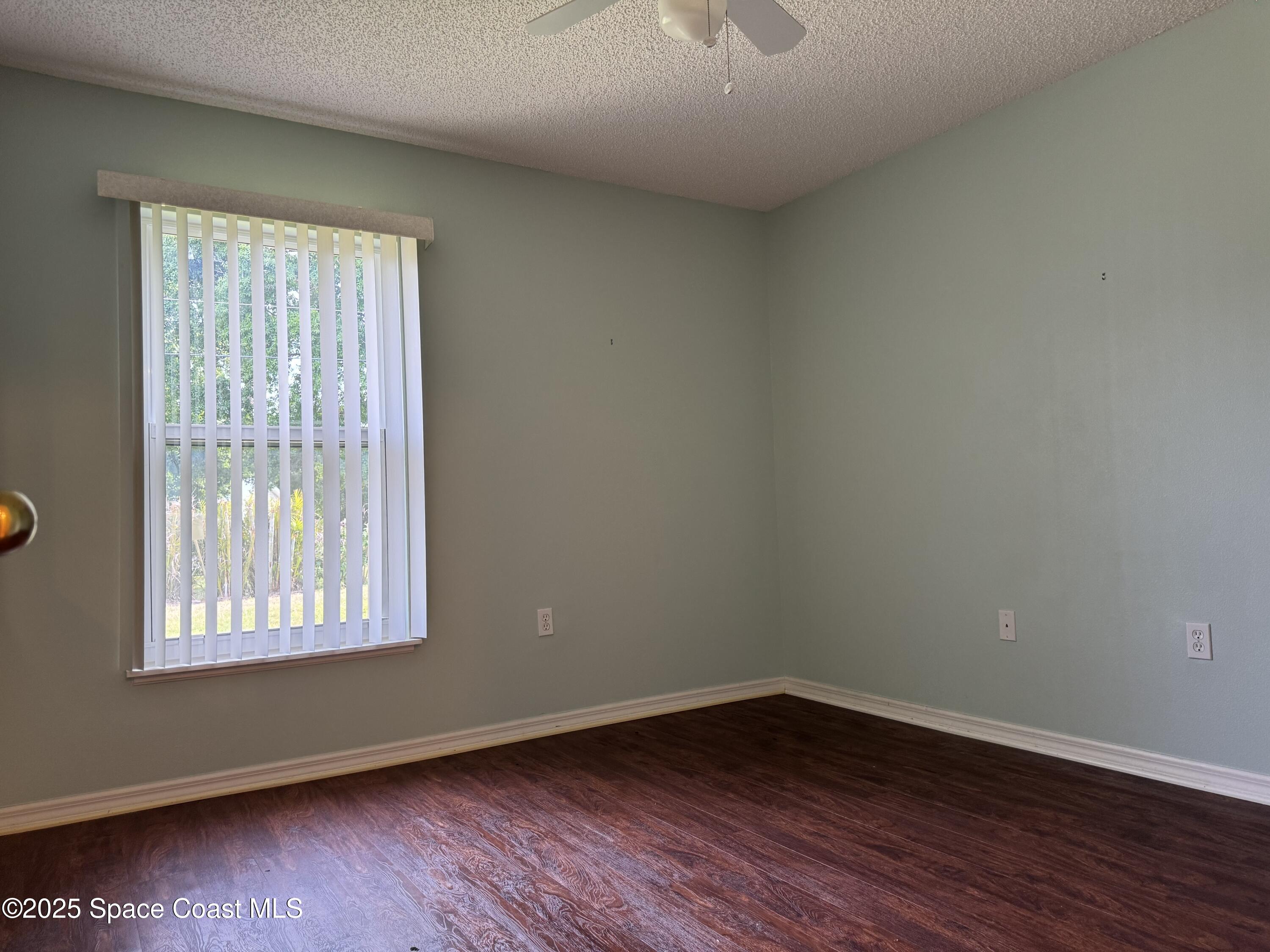 Undisclosed Address Palm Bay, FL 32909 - Photo 13 of 20 an empty room with wooden floor and windows