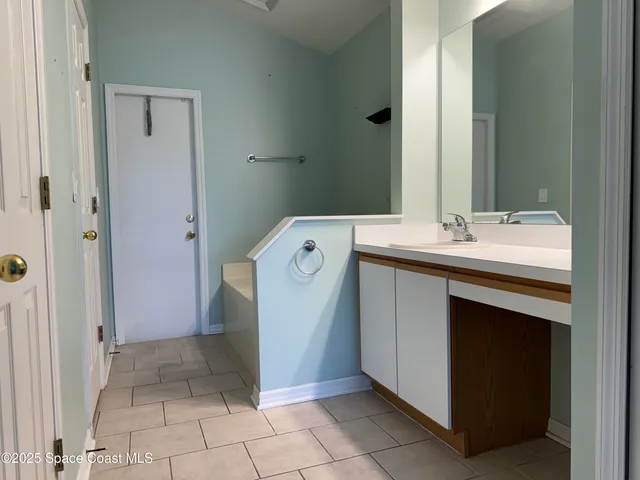 a utility room with cabinets washer and dryer