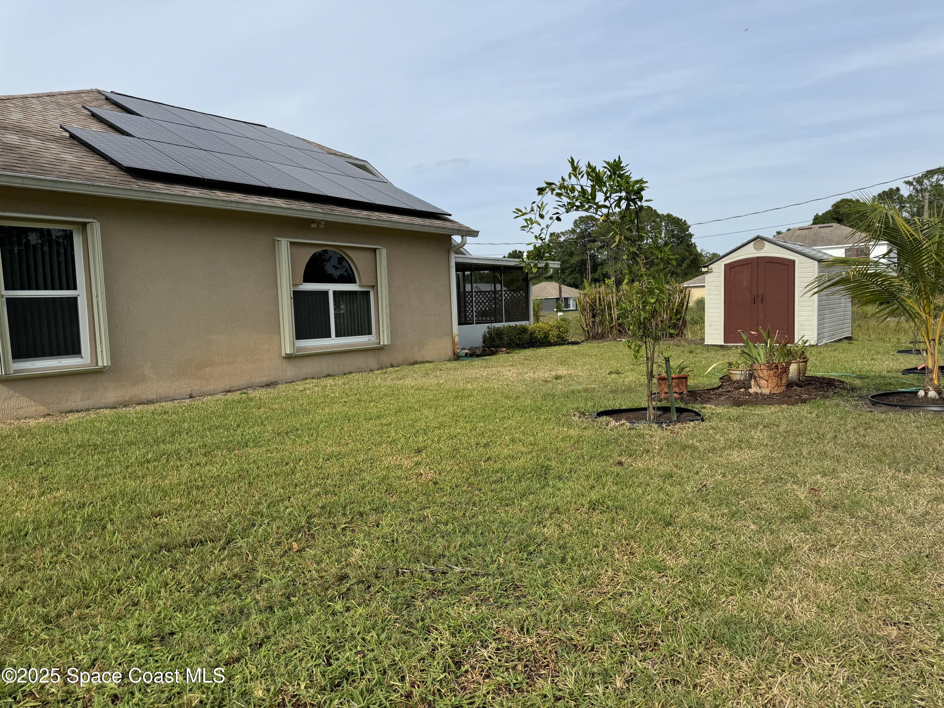 Undisclosed Address Palm Bay, FL 32909 - Photo 18 of 20 a house view with a garden space
