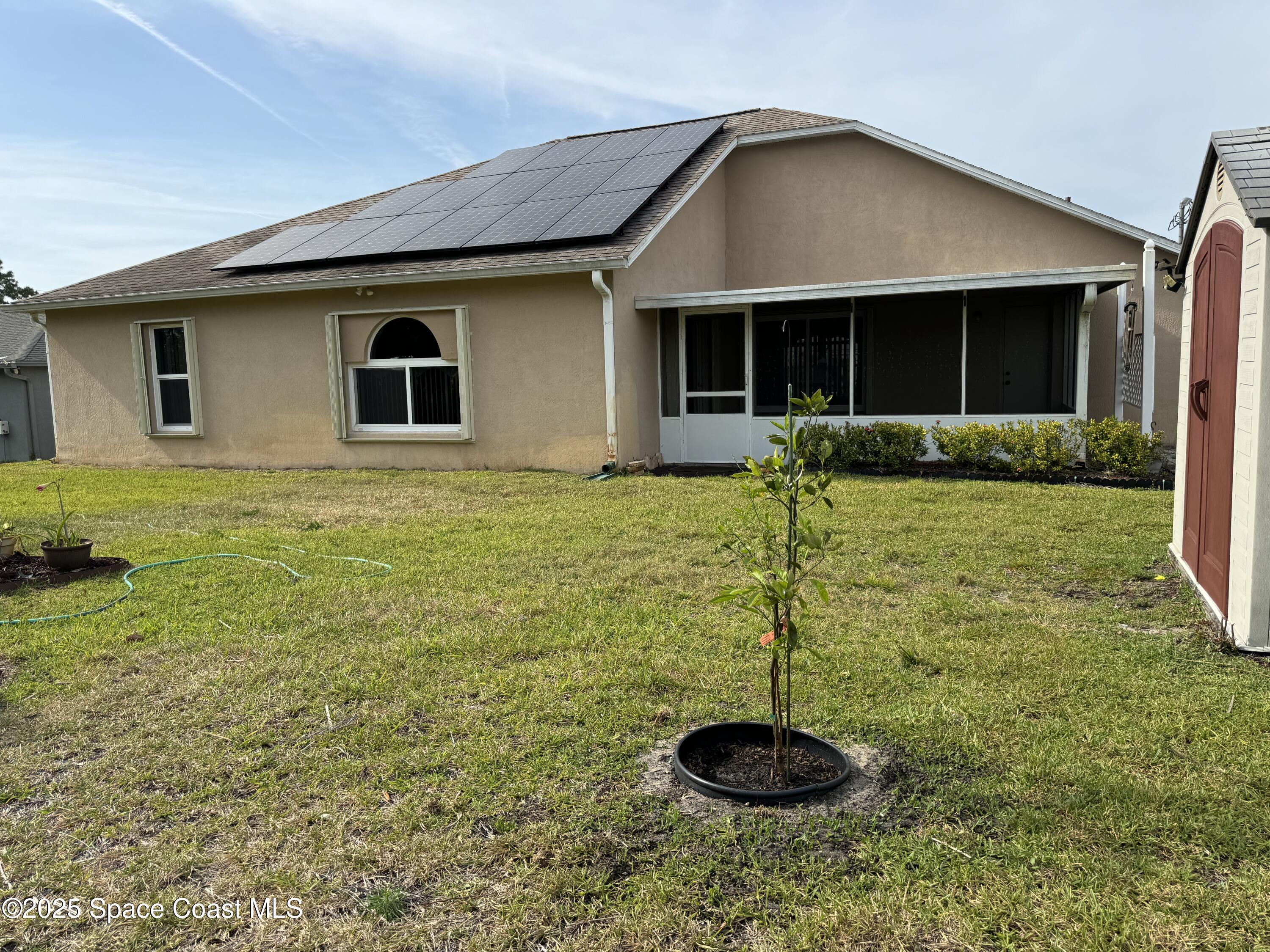 Undisclosed Address Palm Bay, FL 32909 - Photo 19 of 20 a backyard of a house with table and chairs