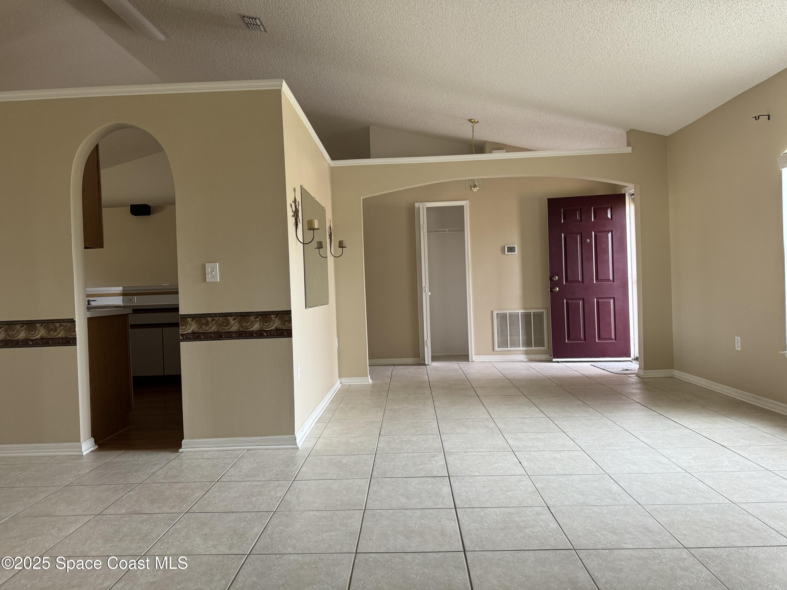 Undisclosed Address Palm Bay, FL 32909 - Photo 4 of 20 a view of a hallway with wooden floor and a kitchen