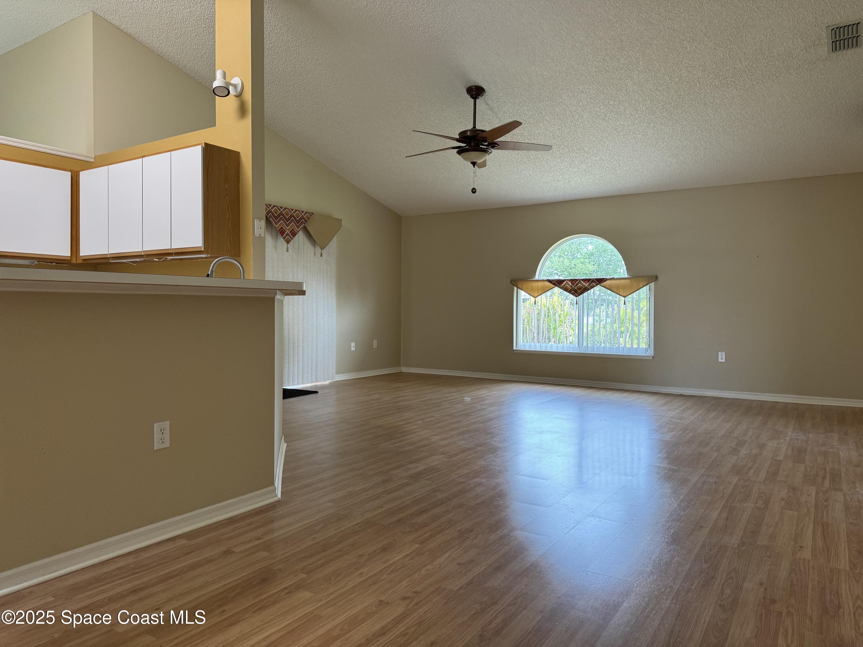 Undisclosed Address Palm Bay, FL 32909 - Photo 6 of 20 an empty room with wooden floor and windows