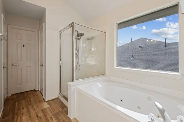 a bathroom with a bathtub and a shower