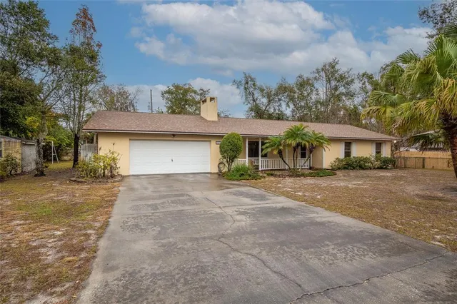 a front view of a house with a yard and a garage