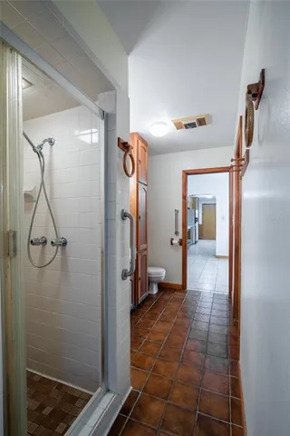 a hallway with a shower and closet