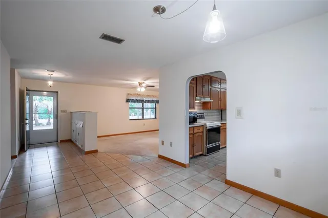 a view of a kitchen with furniture and an empty room
