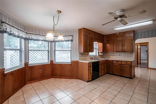 a large kitchen with granite countertop a stove a sink dishwasher and a refrigerator