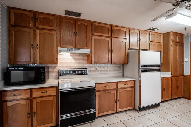 a kitchen with a stove microwave and refrigerator