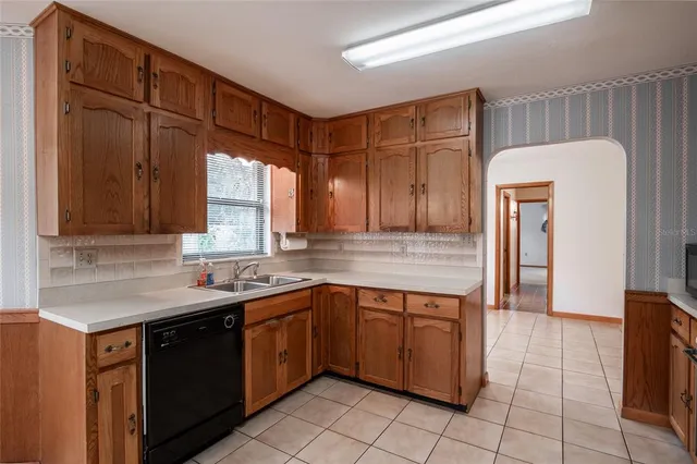 a kitchen with a sink window and cabinets
