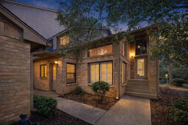 a view of a house with brick walls and windows
