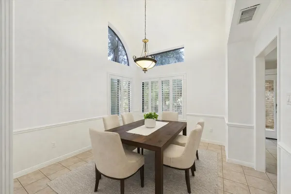 a view of a dining room with furniture and a floor to ceiling window