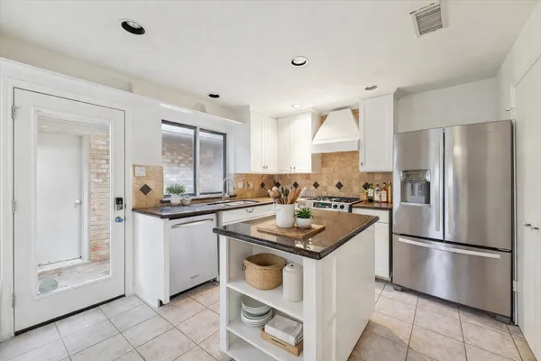 a kitchen with a stove sink and refrigerator