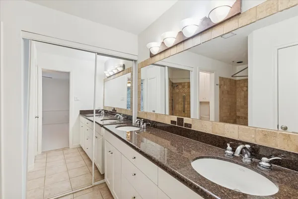 a bathroom with a sink double vanity and a mirror