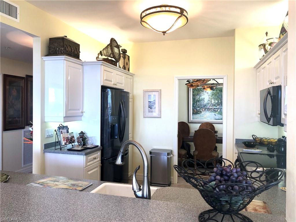 451 Bayfront Place, Unit 5311 Naples, FL 34102 - Photo 21 of 38 a living room with furniture a flat screen tv and a fireplace