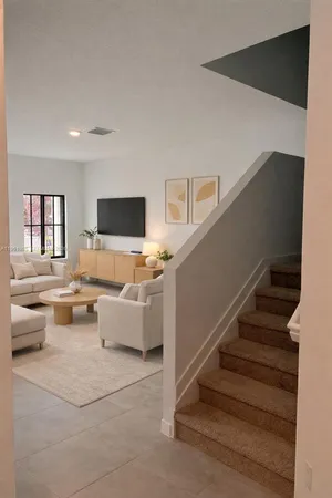 a living room with furniture and a flat screen tv