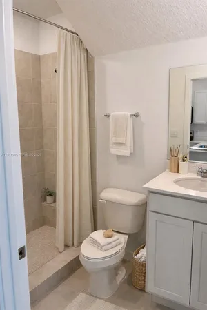 a bathroom with a toilet a sink and a shower
