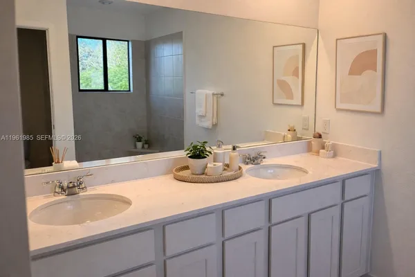 a bathroom with a double vanity sink and a mirror