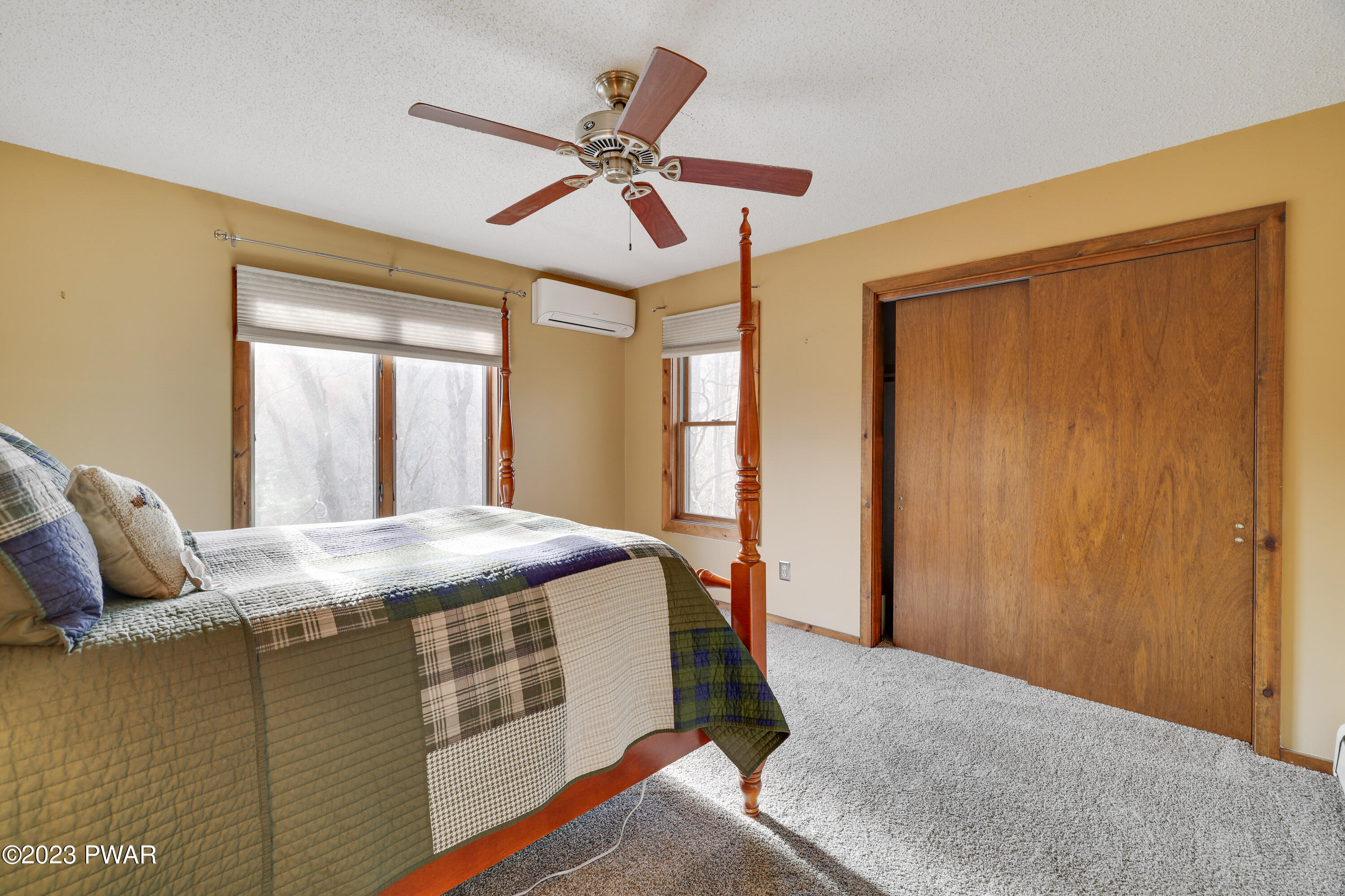 6348 Decker Road Bushkill, PA 18324 - Photo 17 of 36 a bed sitting in a spacious bedroom next to a window
