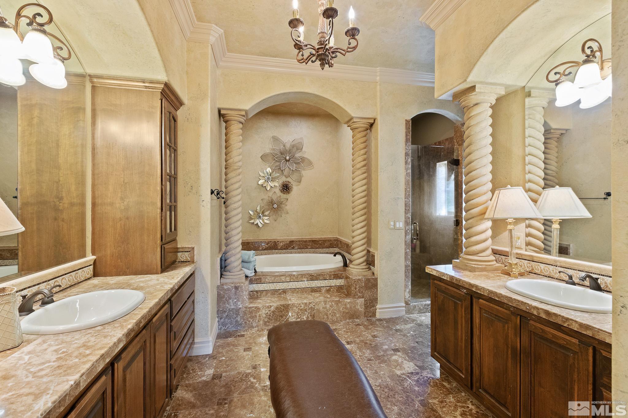 4885 Mountainshyre Road Reno, NV 89519 - Photo 21 of 39 a spacious bathroom with a granite countertop sink a mirror a bathtub and shower