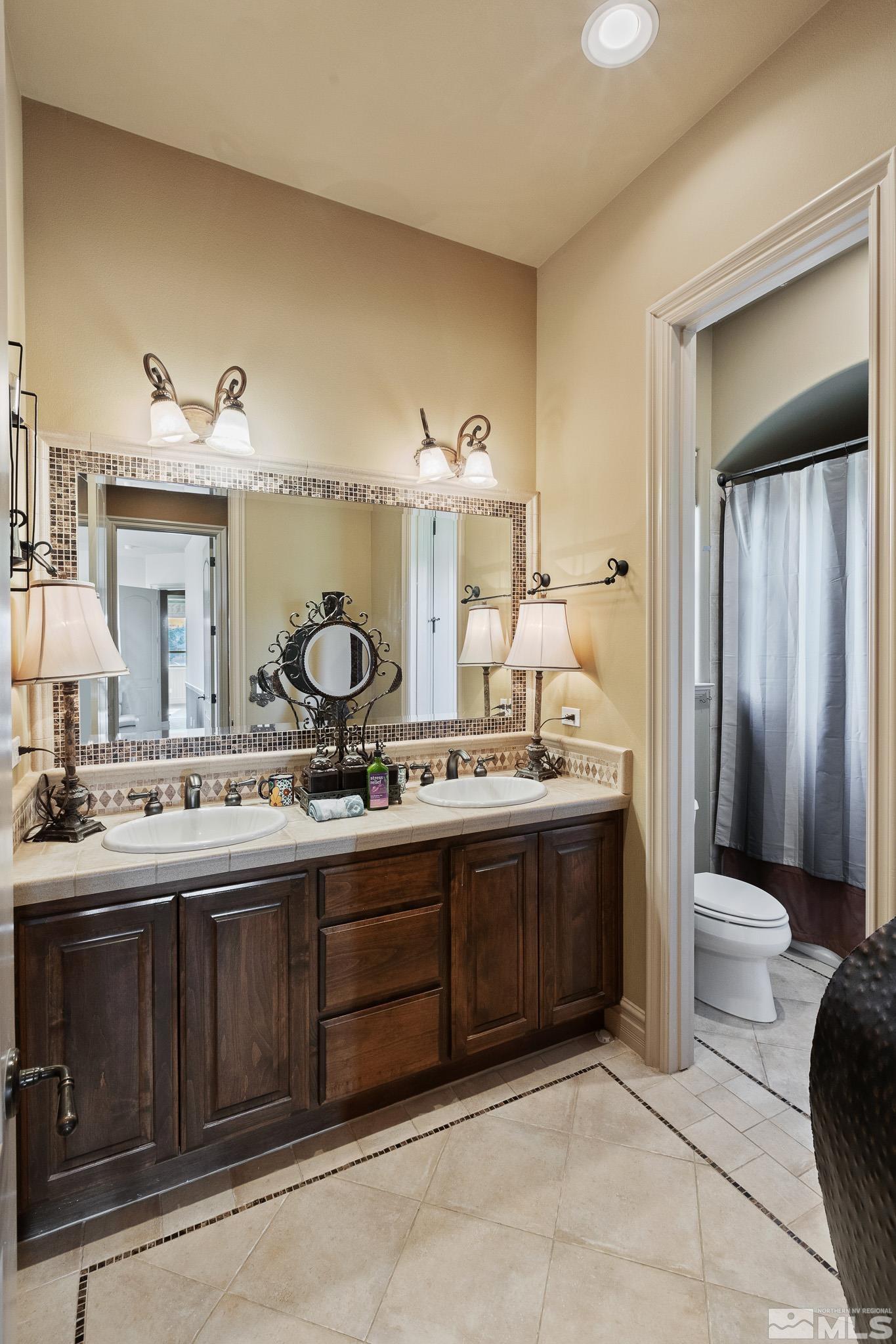4885 Mountainshyre Road Reno, NV 89519 - Photo 27 of 39 a spacious bathroom with a granite countertop sink and a mirror