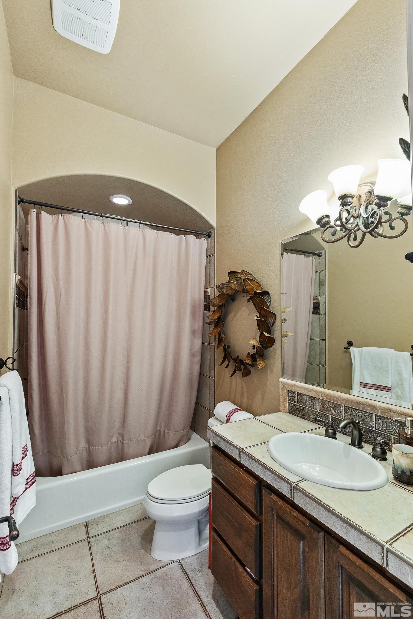 4885 Mountainshyre Road Reno, NV 89519 - Photo 32 of 39 a bathroom with a granite countertop sink a toilet and a mirror