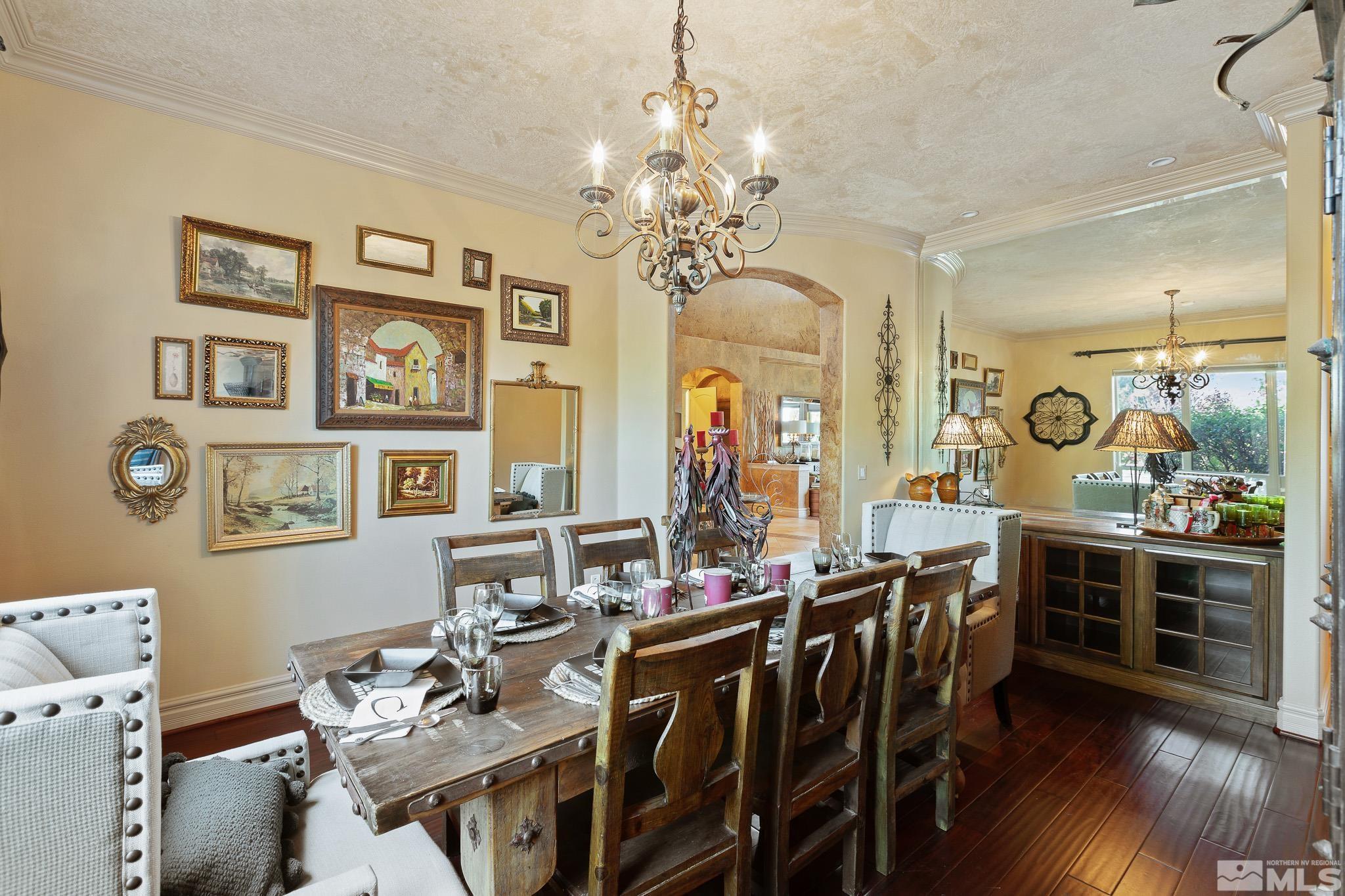 4885 Mountainshyre Road Reno, NV 89519 - Photo 6 of 39 a view of a dining room with furniture a chandelier and wooden floor