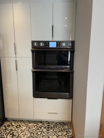 a kitchen with stainless steel appliances granite countertop a sink a stove and a refrigerator