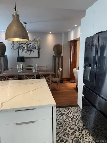 a dining room with furniture and wooden floor