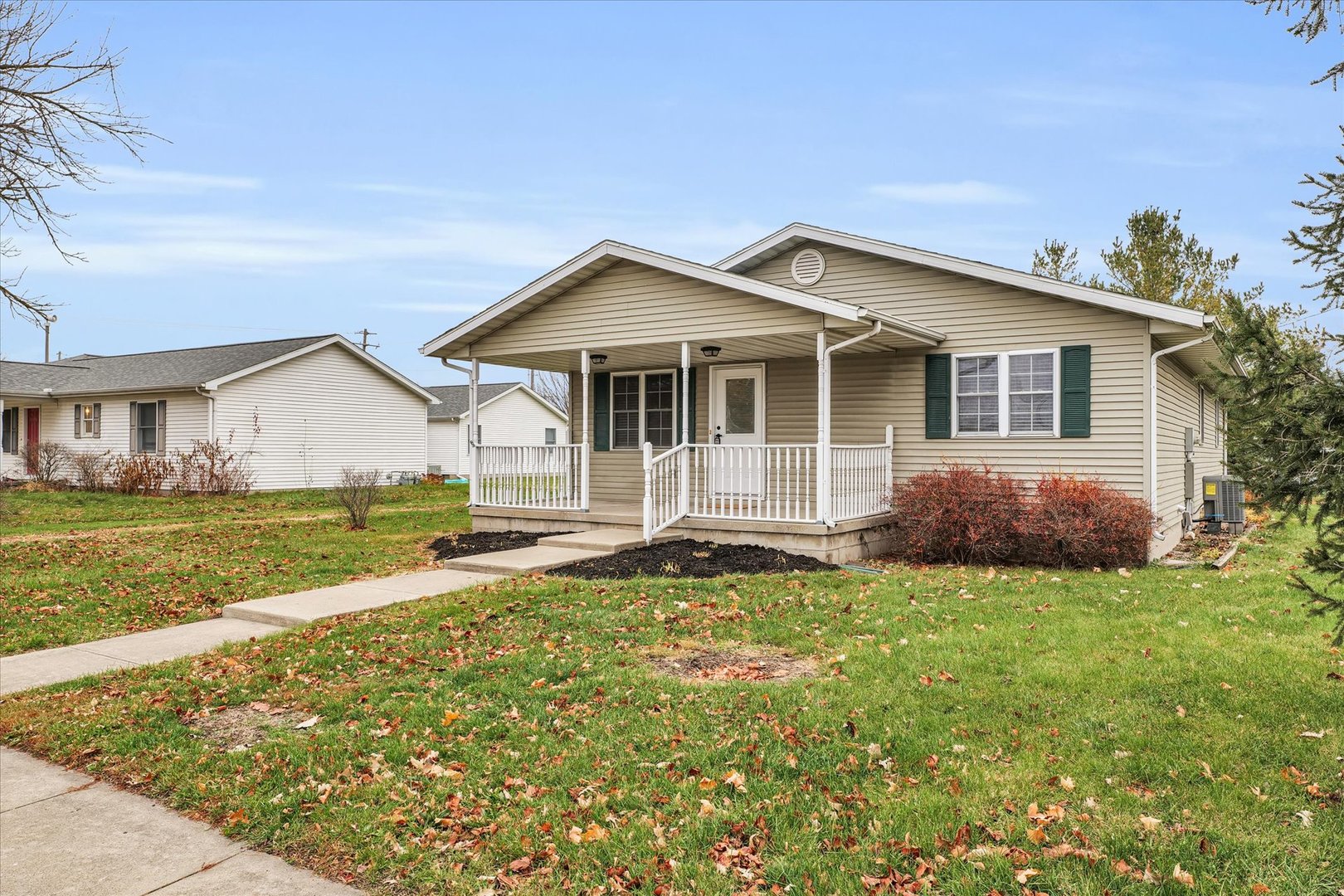 a view of a house with a yard and fence