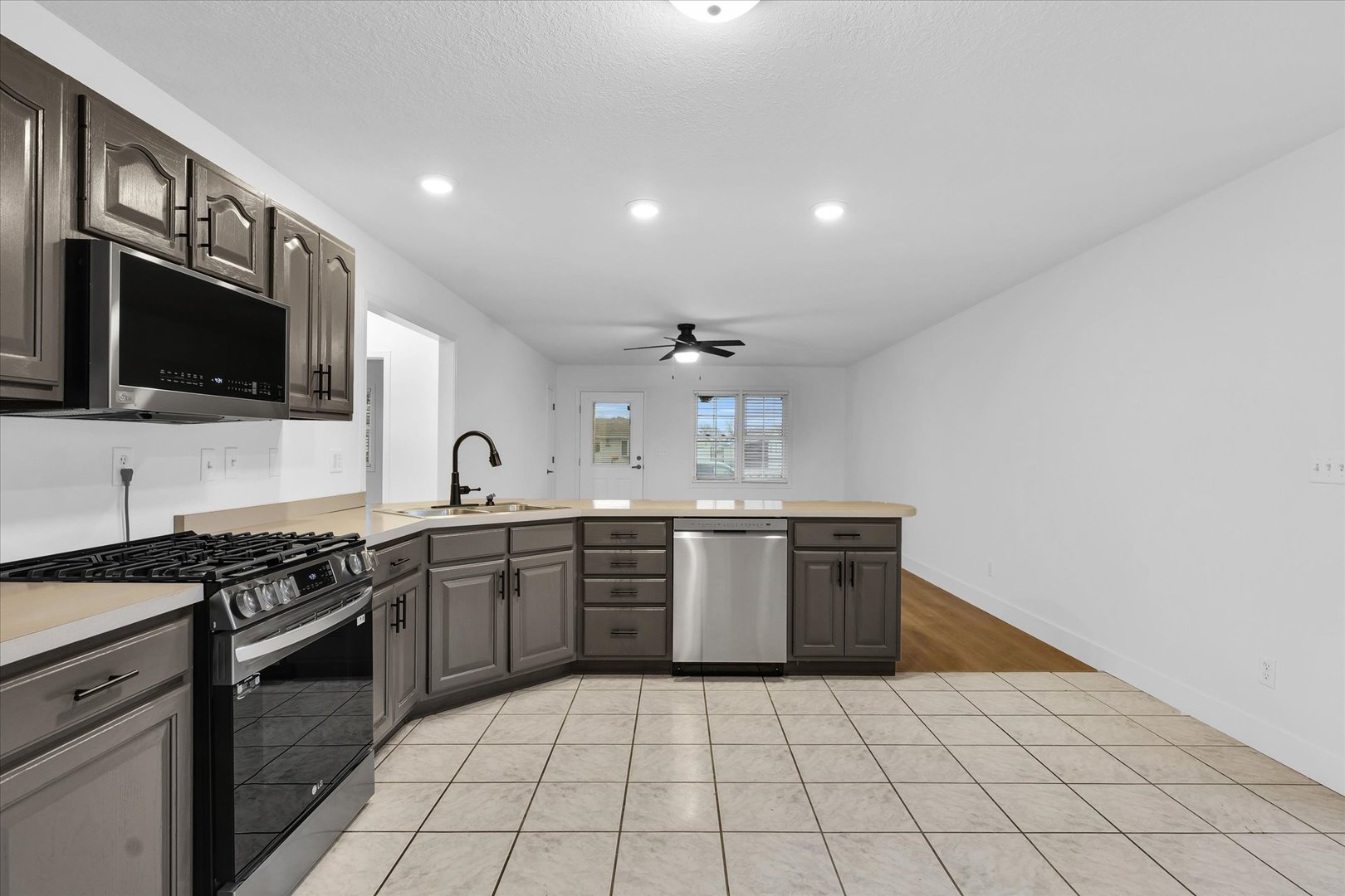 203 West Main Street Ogden, IL 61859 - Photo 11 of 27 a large kitchen with stainless steel appliances granite countertop a sink and a stove