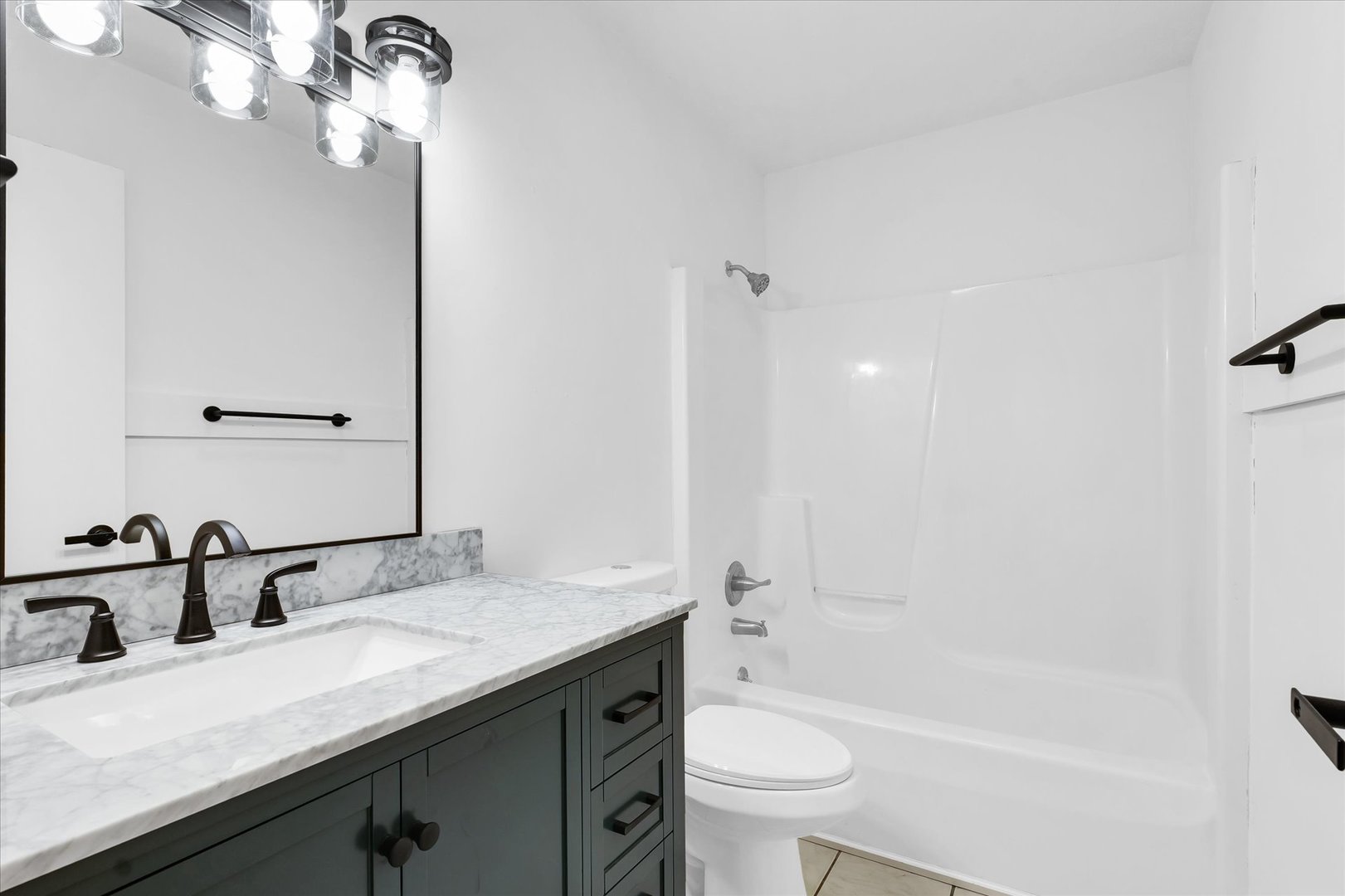 203 West Main Street Ogden, IL 61859 - Photo 16 of 27 a bathroom with a granite countertop sink a toilet and bathtub