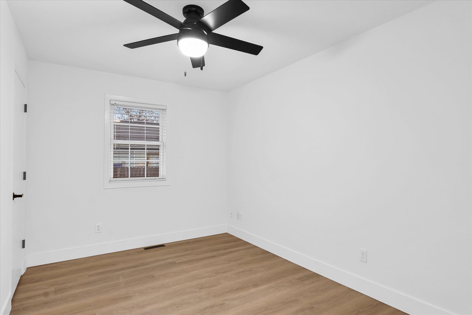 203 West Main Street Ogden, IL 61859 - Photo 18 of 27 an empty room with a window and a ceiling fan