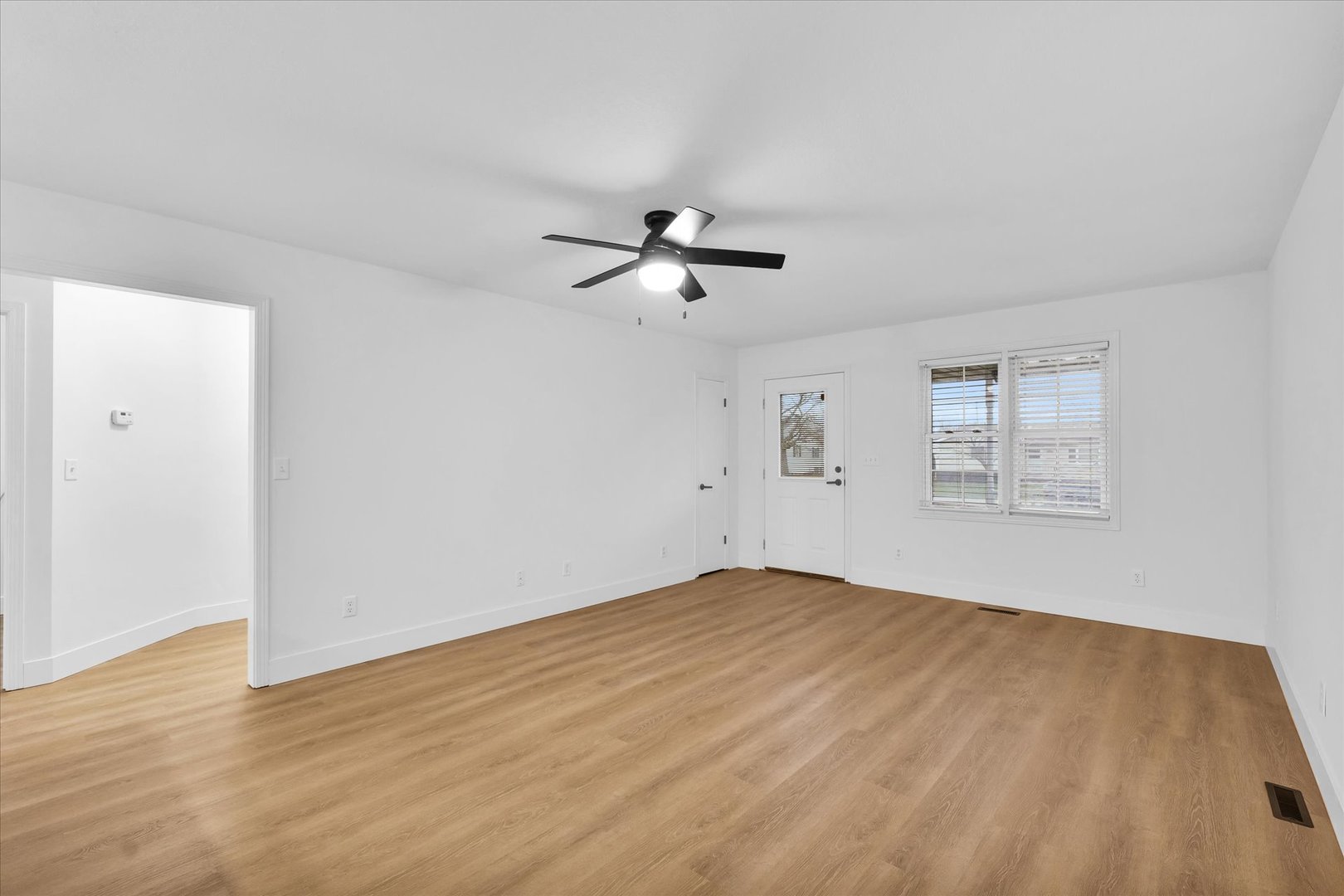 203 West Main Street Ogden, IL 61859 - Photo 7 of 27 an empty room with fan and windows