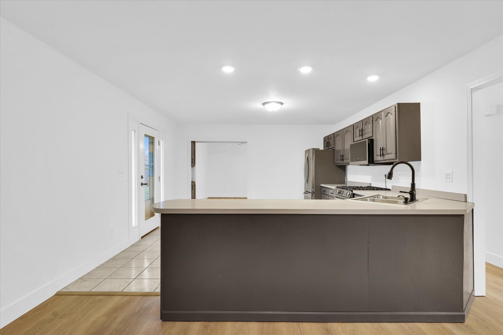 203 West Main Street Ogden, IL 61859 - Photo 8 of 27 a kitchen with stainless steel appliances granite countertop a sink a stove and a refrigerator