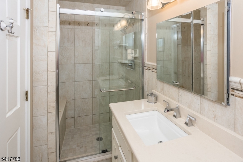 10 Torlish Gate Raritan, NJ 08869 - Photo 21 of 40 a bathroom with a shower sink and mirror