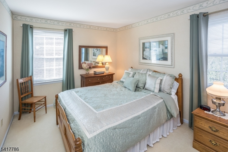 10 Torlish Gate Raritan, NJ 08869 - Photo 23 of 40 a bedroom with a bed and a dresser next to a window