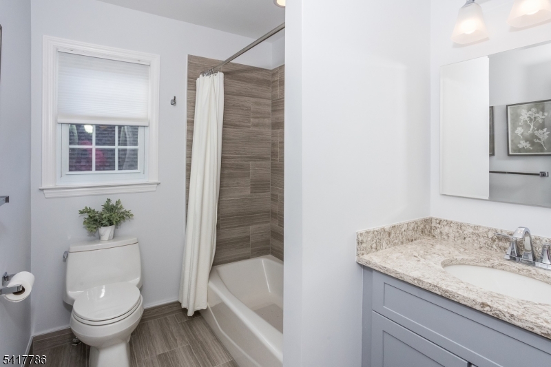 10 Torlish Gate Raritan, NJ 08869 - Photo 25 of 40 a bathroom with a granite countertop sink toilet and shower
