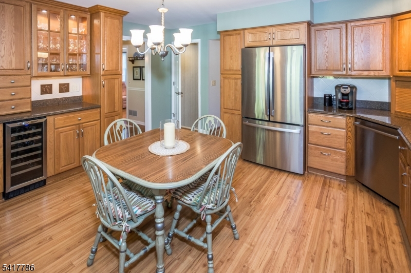 10 Torlish Gate Raritan, NJ 08869 - Photo 6 of 40 a kitchen with stainless steel appliances a dining table chairs refrigerator and sink