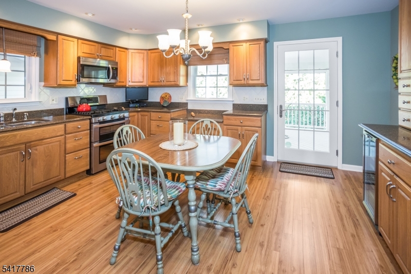 10 Torlish Gate Raritan, NJ 08869 - Photo 8 of 40 a kitchen with a table chairs sink and cabinets