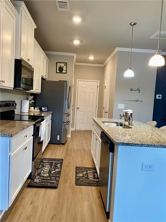 5149 Fox Den Road Oakwood, GA 30566 - Photo 12 of 44 a kitchen with a sink stove and refrigerator