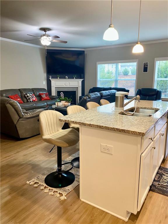 5149 Fox Den Road Oakwood, GA 30566 - Photo 13 of 44 a living room with kitchen island furniture a fireplace and a chandelier
