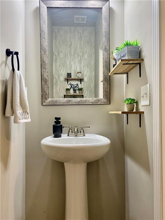 5149 Fox Den Road Oakwood, GA 30566 - Photo 18 of 44 a bathroom with a sink a mirror and vanity