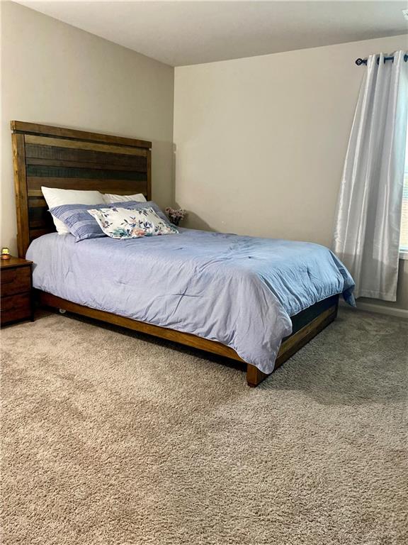 5149 Fox Den Road Oakwood, GA 30566 - Photo 20 of 44 a bed sitting in a bedroom next to a window