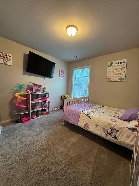 5149 Fox Den Road Oakwood, GA 30566 - Photo 25 of 44 a bedroom with furniture and flat screen tv