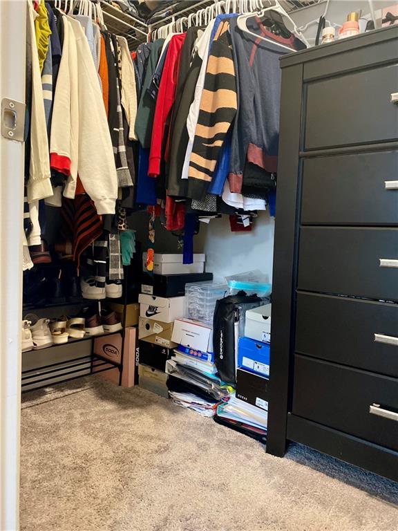 5149 Fox Den Road Oakwood, GA 30566 - Photo 28 of 44 a view of walk in closet with clothes and shoes