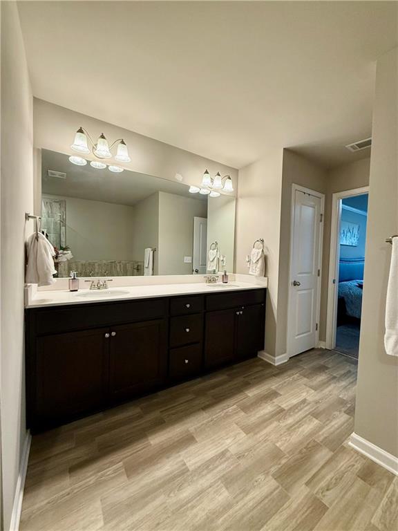 5149 Fox Den Road Oakwood, GA 30566 - Photo 30 of 44 a spacious bathroom with a double vanity sink and a mirror
