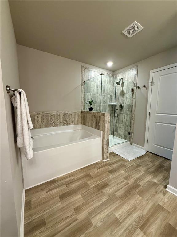 5149 Fox Den Road Oakwood, GA 30566 - Photo 31 of 44 a spacious bathroom with a bathtub and shower