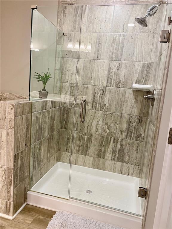 5149 Fox Den Road Oakwood, GA 30566 - Photo 32 of 44 a bathroom with a shower and a bath tub